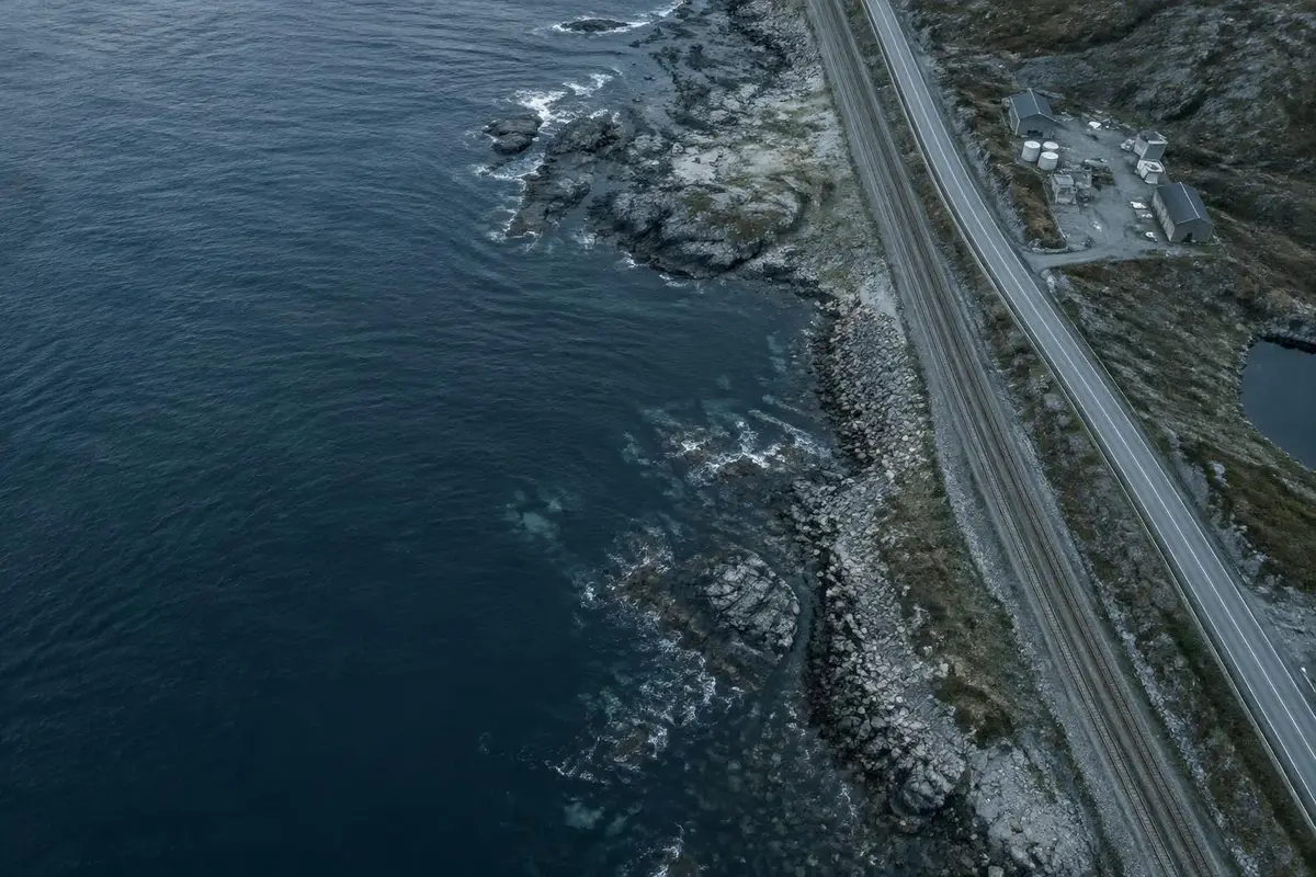 Aerial view of coastal landscape, road and railway infrastructure