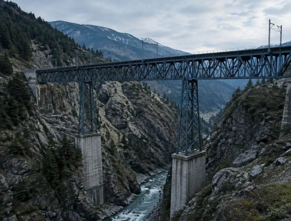 Steel railway viaduct crossing a rocky mountain gorge